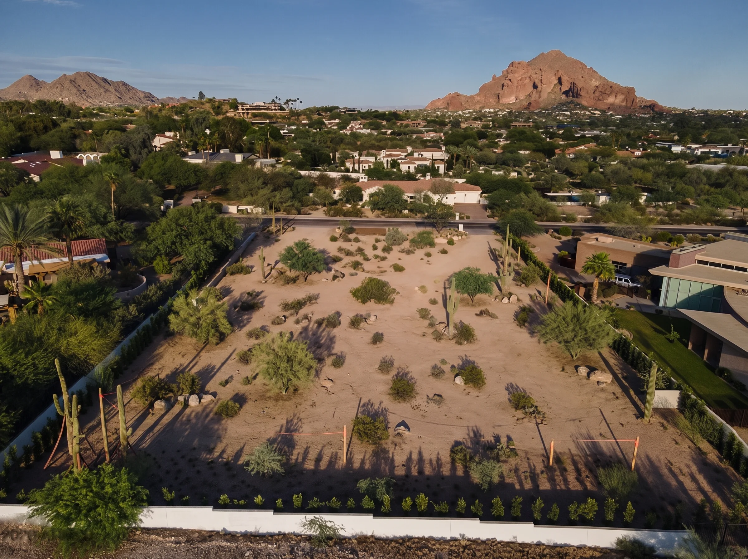 Raw desert lot in Phoenix, Arizona before construction — illustrative rendering